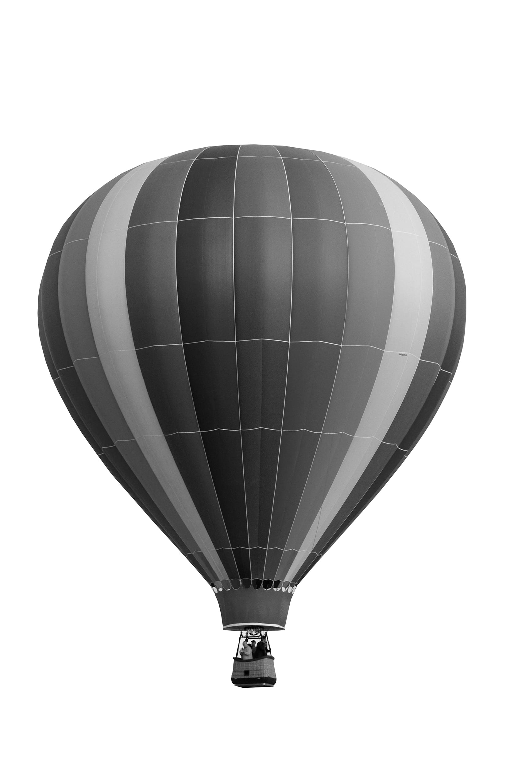 Black and white image of a striped hot air balloon among the clouds