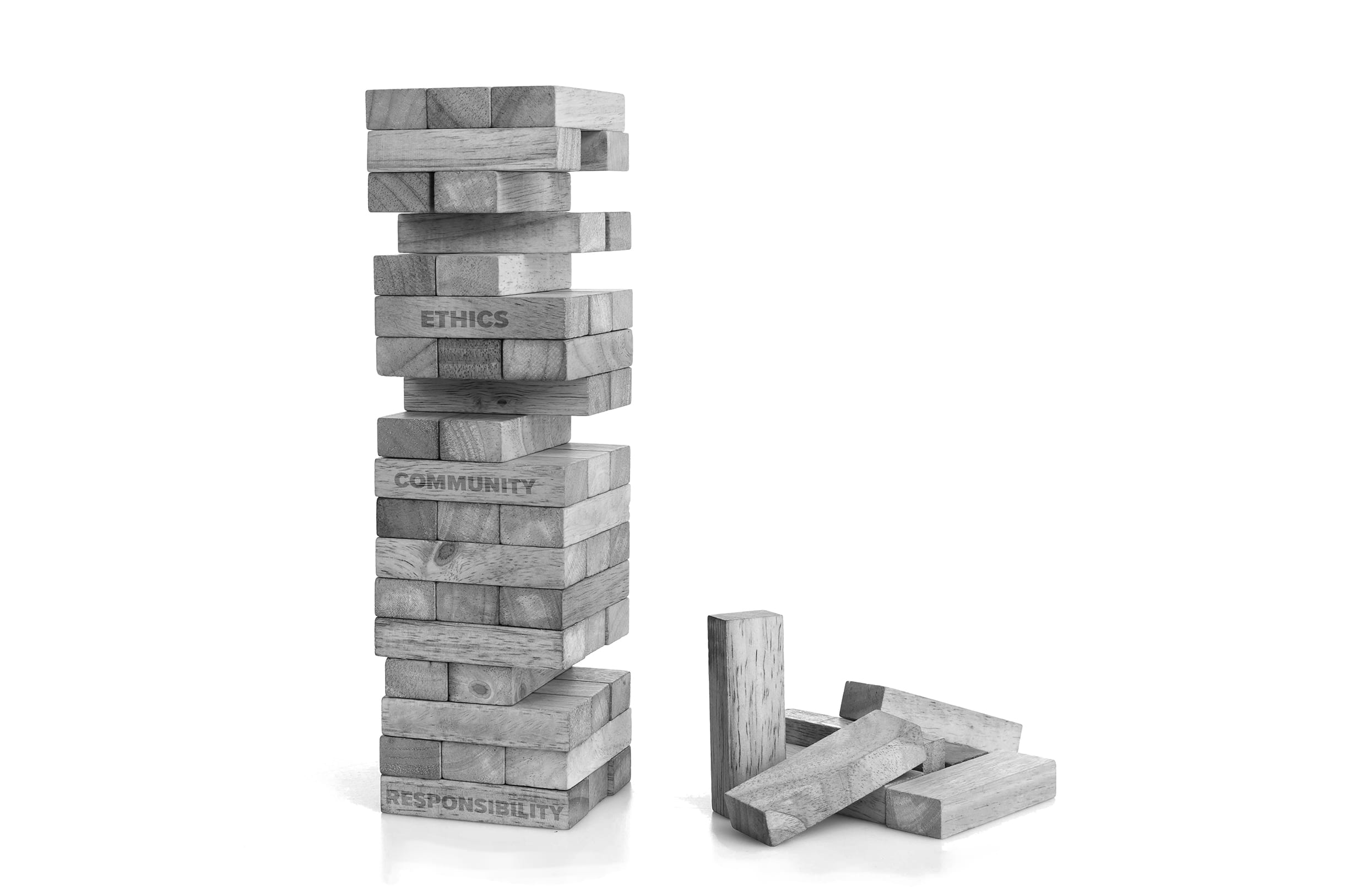 Stack of Jenga blocks with a close up on the words, Ethics, Community and Responsibility