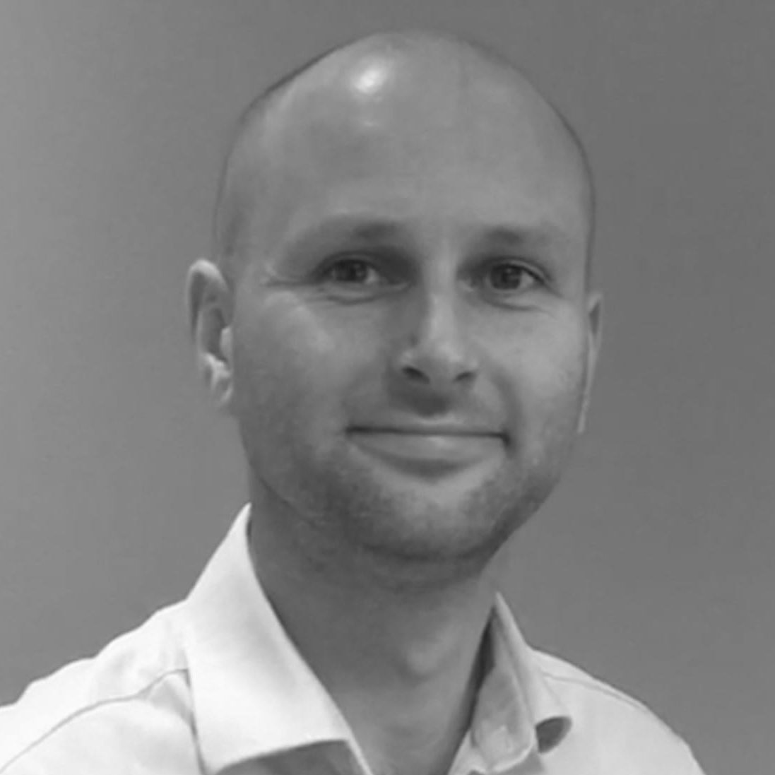 James York smiles in a black and white image