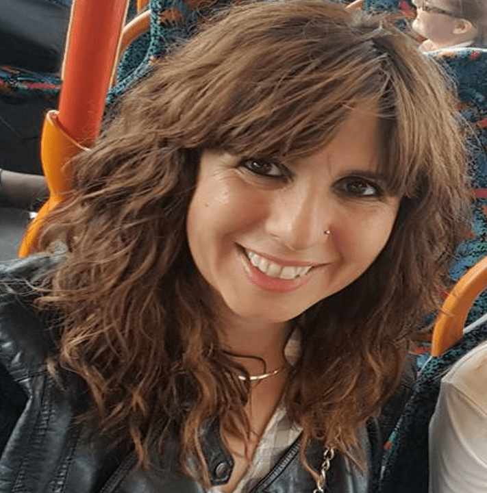 Karen Marshall sitting on a bus, smiling