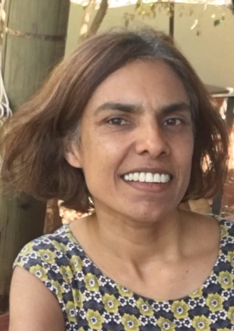 Maya de Souza turning her head towards the camera