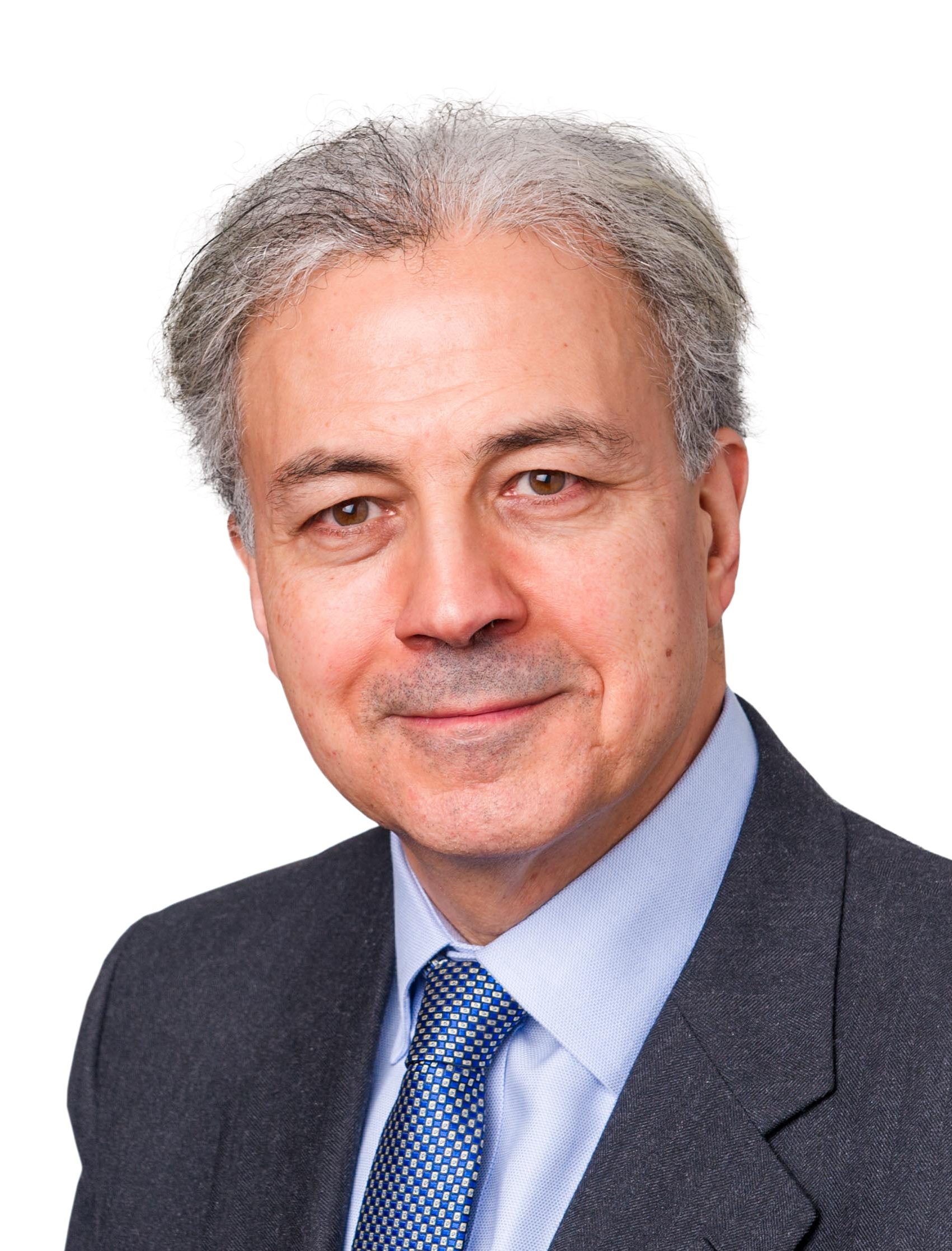 Saker Nusseibeh in a blue suit and blue tie.