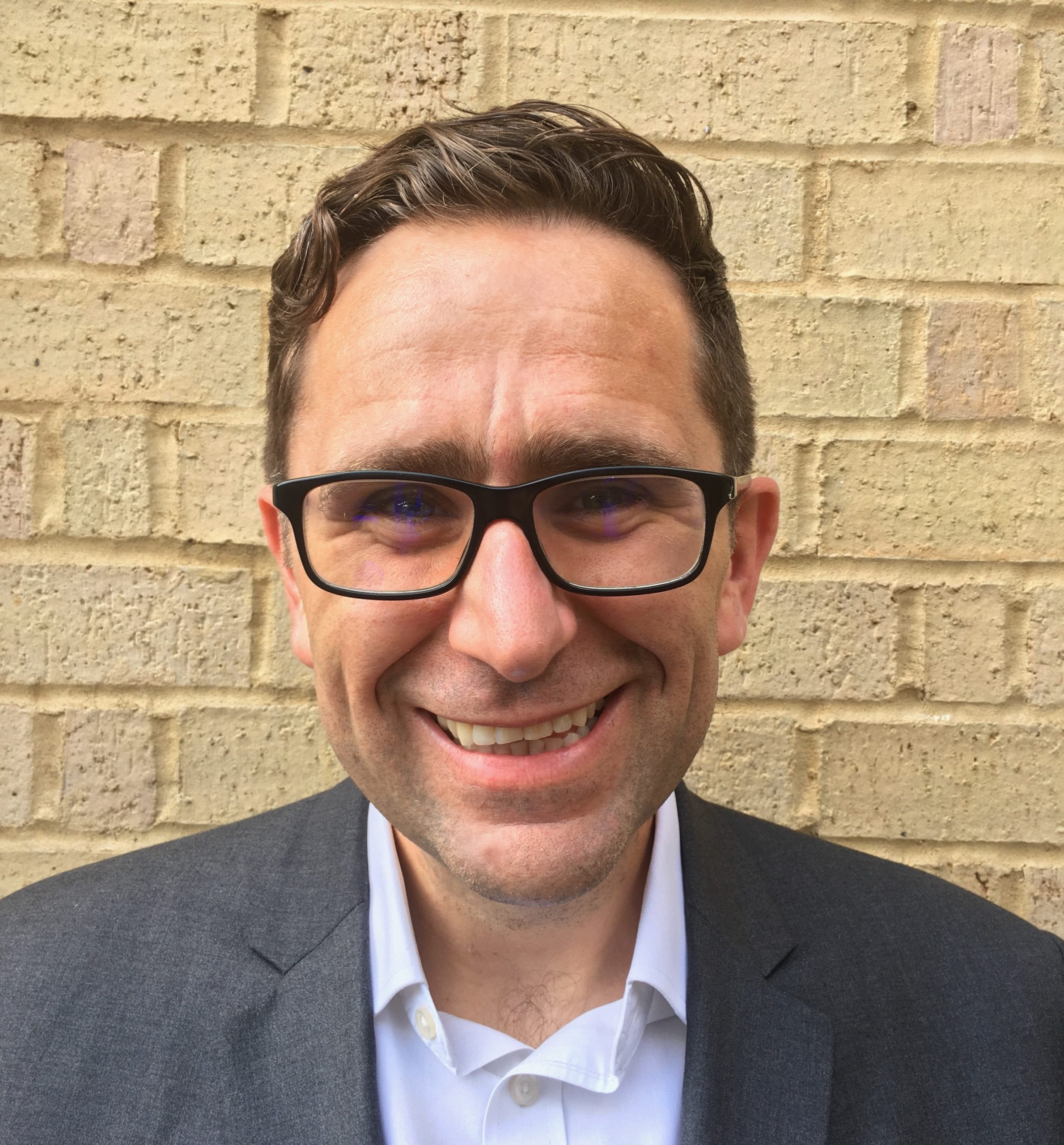 Simon Earles smiles into the camera