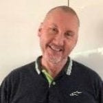 Derek Kilday smiles with his head tilted