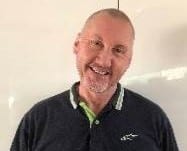 Derek Kilday smiles with his head tilted