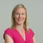 Catherine Hall wearing a pink dress, smiling