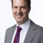 Robin Nuttall in a tie and smiling at the camera.