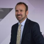Peter Duff smiling in a suit