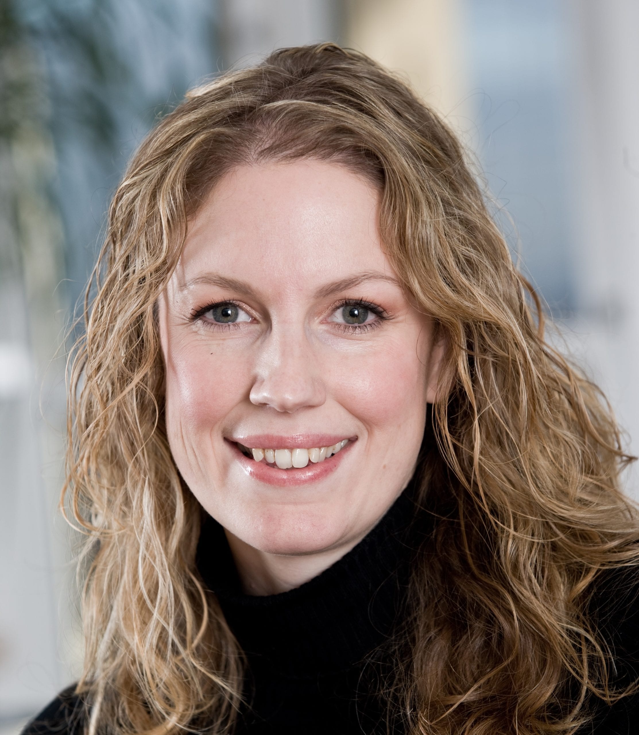 Julie Taylor in a black jumper smiles