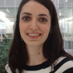 Pauline wearing a black and white striped top, smiles towards the camera