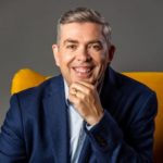 Andrew finalyson sitting on a yellow chair