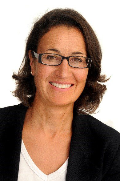 Rosie Barclay wearing glasses and smiling at the camera.