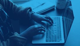 An image of a person on a laptop