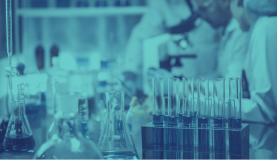 An image of a chemistry lab with beakers and scientists working in the background