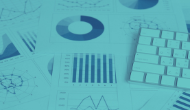 An image of lots of charts and a keyboard representing working on a  responsible business strategy