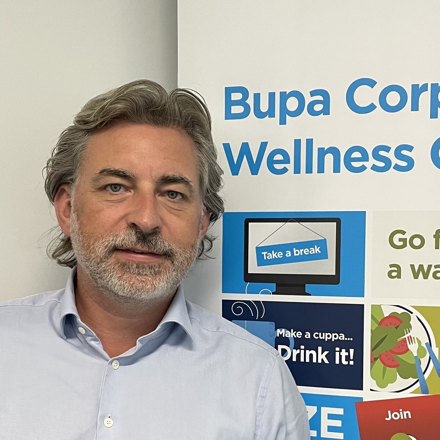 Will Shaw in front of a display board