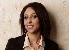 Satinder Kaur, standing looking at the camera, against a white background.
